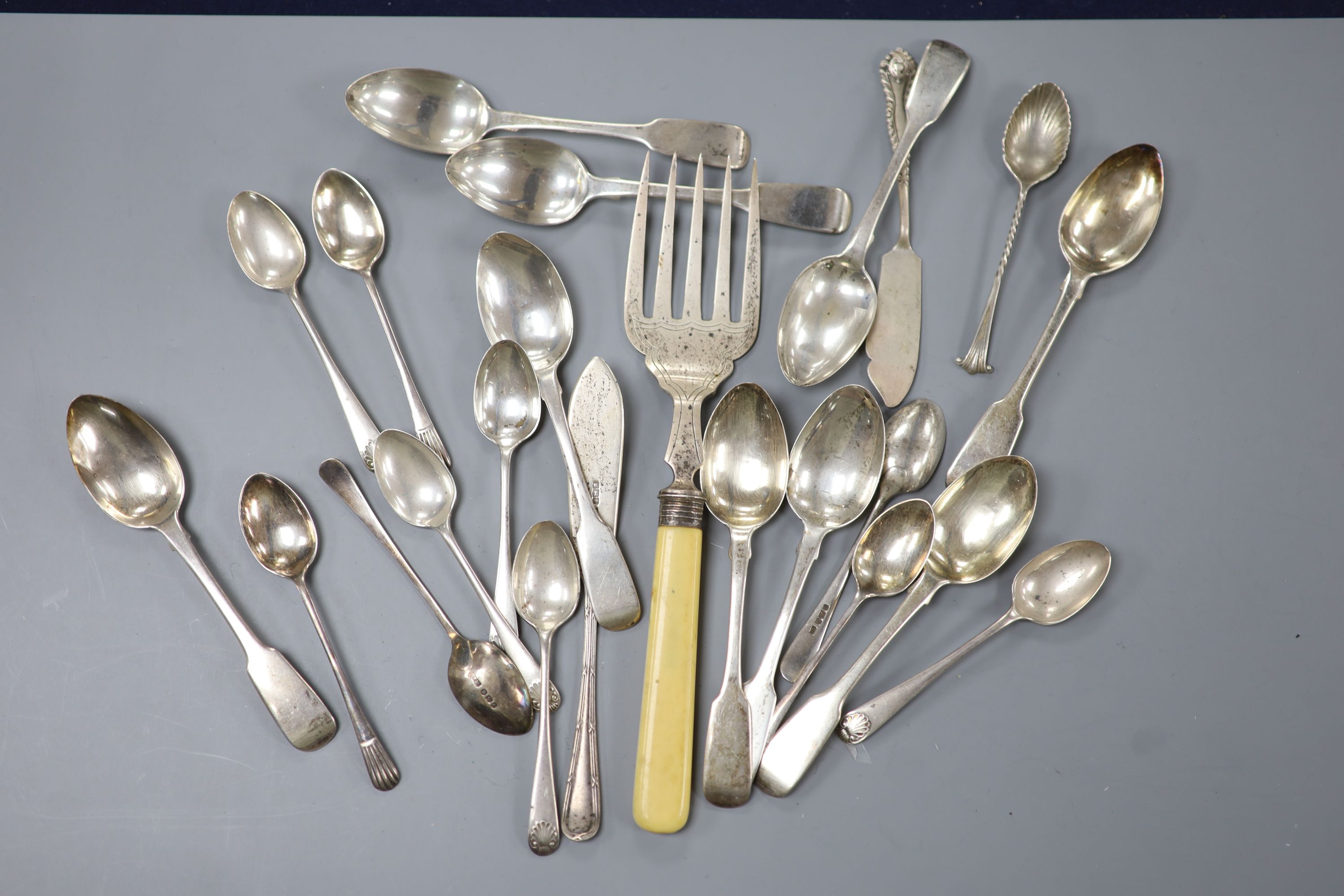 A set of nine George IV silver fiddle pattern teaspoons, London , 1821, two later sets of six silver teaspoons, one cased, five other silver teaspoons, a silver butter knife and an ivory handled silver serving fork